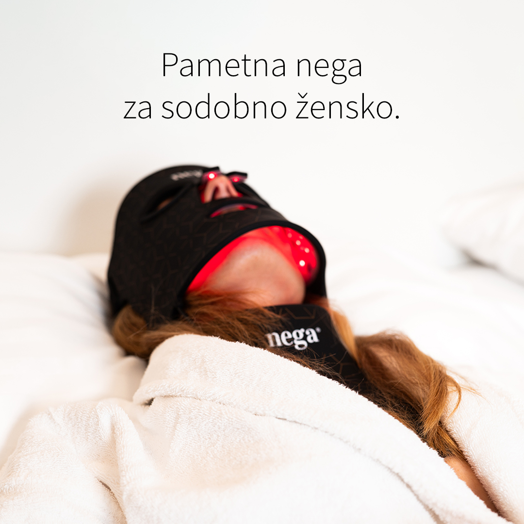 Woman using LuxGlow LED mask in bed